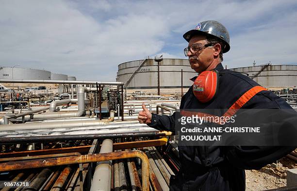 Workman stands at the site of the mediterranean refinery of Lavera which belongs to British group Ineos, taken on April 26, 2010 in Martigues,...