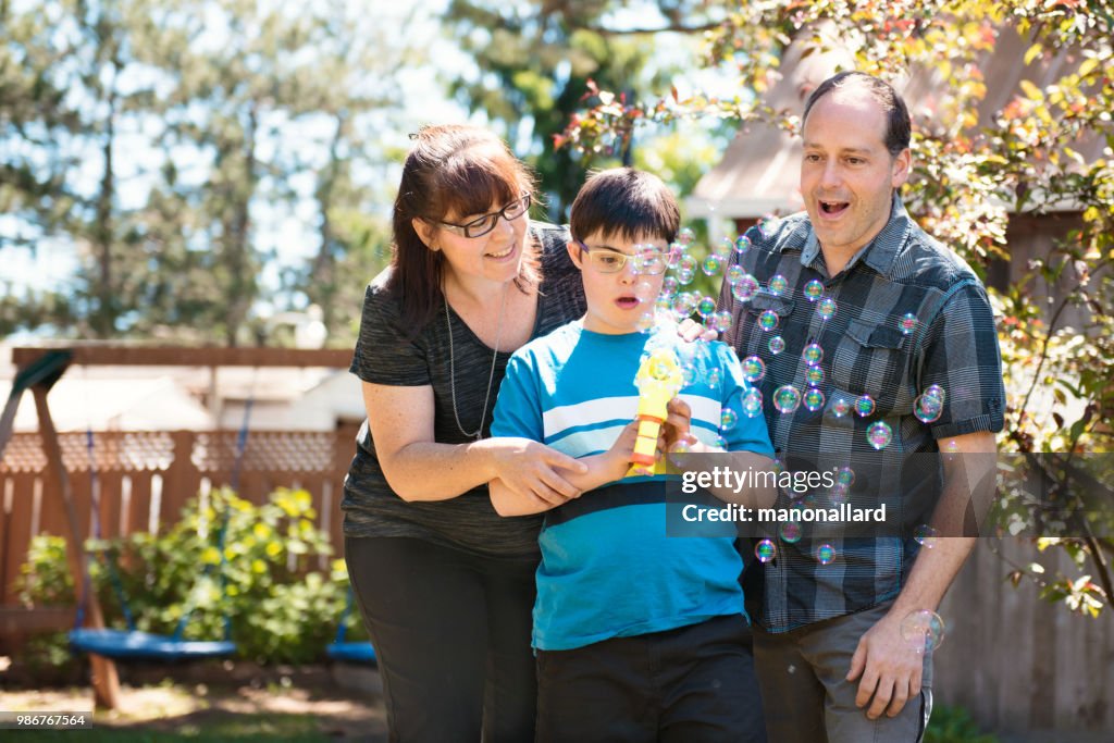 Parents with their autistic and down syndrome child in daily lives