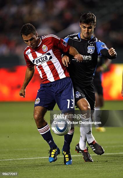 Chris Wondolowski of the San Jose Earthquakes and Jonathan Bornstein of Chivas USA vie for the ball in the first half during their MLS match at the...