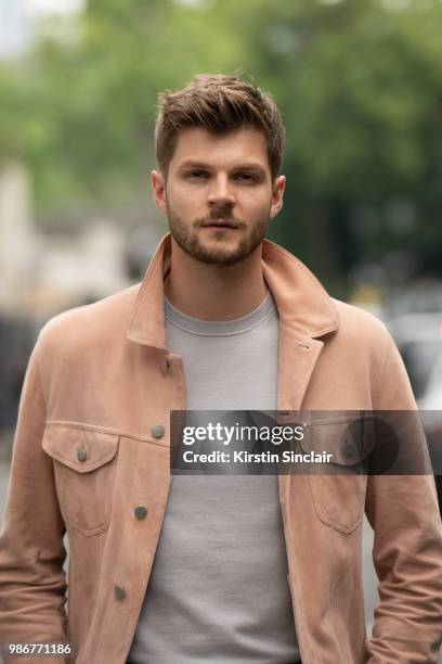Digital Influencer and Vlogger Jim Chapman wears a Dunhill jacket, Reiss T shirt during London Fashion Week Men's on June 9, 2018 in London, England.