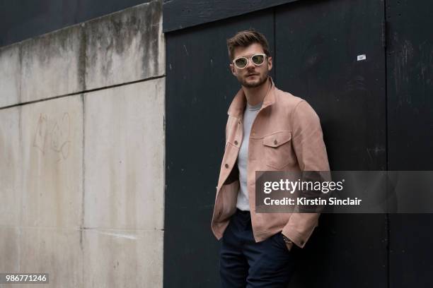 Digital Influencer and Vlogger Jim Chapman wears a Dunhill jacket, Reiss T shirt, Burberry trousers, Taylor Morris sunglasses during London Fashion...