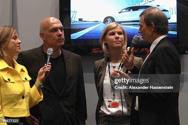 Christian Gross , head coach of soccer club VfB Stuttgart and Anke Huber are interviewed at the VIP room during day one of the WTA Porsche Tennis...