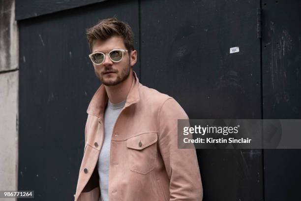 Digital Influencer and Vlogger Jim Chapman wears a Dunhill jacket, Reiss T shirt and Taylor Morris sunglasses during London Fashion Week Men's on...
