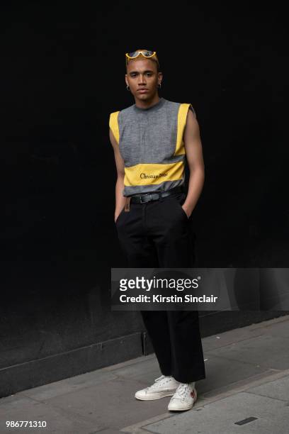 Model and Stylist Jordan Archer wears Christian Dior top, Dolce and Gabbana jeans, Commes Des Garcon for Converse trainers during London Fashion Week...