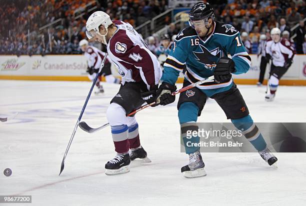 John-Michael Liles of the Colorado Avalanche and Devin Setoguchi of the San Jose Sharks struggle for control of the puck in Game Five of their...