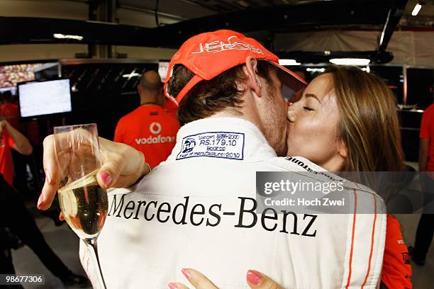 Jenson Button of Great Britain and McLaren Mercedes celebrates in his team garage with his girlfriend Jessica Michibata after winning the Chinese...