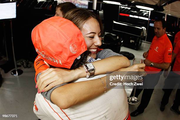 Jenson Button of Great Britain and McLaren Mercedes celebrates in his team garage with his girlfriend Jessica Michibata after winning the Chinese...