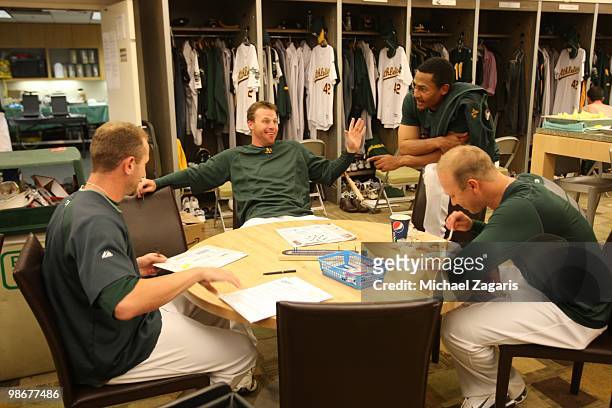 Gabe Gross, Dallas Braden, Eric Patterson, and Michael Wuertz of the Oakland Athletics relaxing in the clubhouse prior to the game against the...