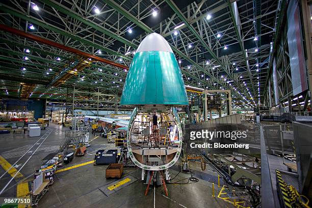 Roger Howe calibrates flight controls in the nose of a Boeing 747-8 cargo plane during final assembly in Everett, Washington, U.S., on Tuesday, March...