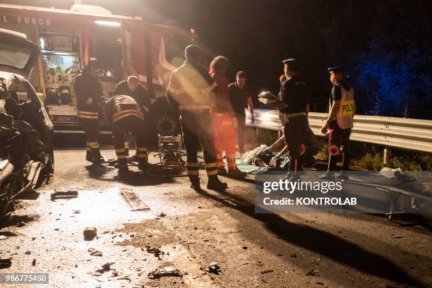 Policemen, doctors and firefighters near the body of Vincenzo Balbi at the accident site along the freeway Ss106 during which he died Vincenzo Balbi...