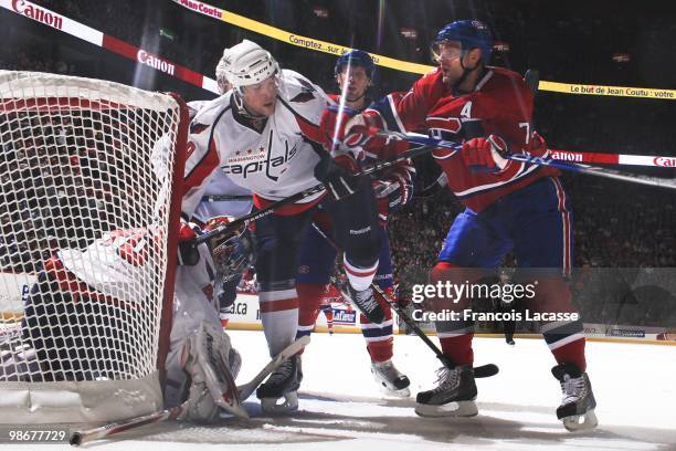 Brendan Morrison of the Washington Capitals battles for the puck with Andrei Markov of Montreal Canadiens in front of Semyon Varlamov of the...