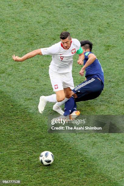 Robert Lewandowski of Poland and Hotaru Yamaguchi of Japan compete for the ball during the 2018 FIFA World Cup Russia group H match between Japan and...