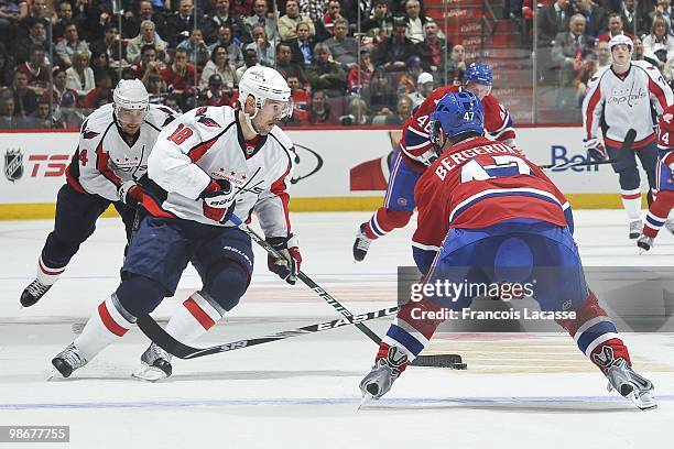 Eric Belanger of the Washington Capitals skates with the puck in front of Marc-Andre Bergeron of Montreal Canadiens in Game Four of the Eastern...