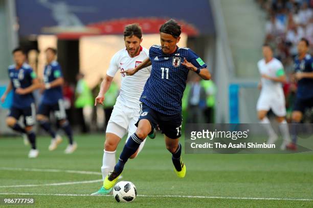Takashi Usami of Japan and Grzegorz Krychowiak of Poland compete for the ball during the 2018 FIFA World Cup Russia group H match between Japan and...