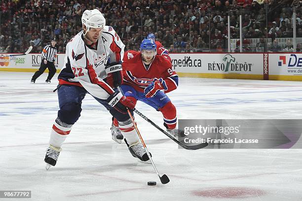 Mike Knuble of the Washington Capitals skates with the puck in front of Tom Pyatt of Montreal Canadiens in Game Four of the Eastern Conference...