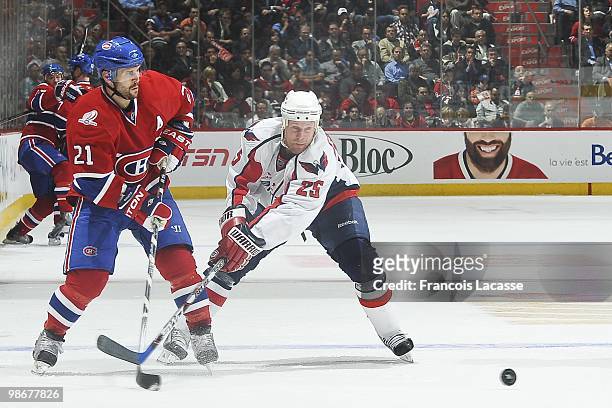 Brian Gionta of Montreal Canadiens takes a shot in front of Jason Chimera of the Washington Capitals in Game Four of the Eastern Conference...