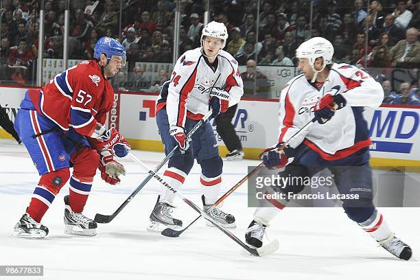 Benoit Pouliot of the Montreal Canadiens battles for the puck with Mike Knuble of the Washington Capitals in Game Four of the Eastern Conference...
