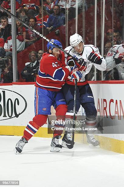 Maxim Lapierre of Montreal Canadiens collides with Tyler Sloan of the Washington Capitals in Game Four of the Eastern Conference Quarterfinals during...