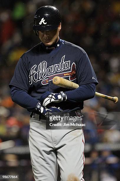 Chipper Jones of the Atlanta Braves walks back to the dugout after striking out in the fifth inning against the New York Mets on April 25, 2010 at...