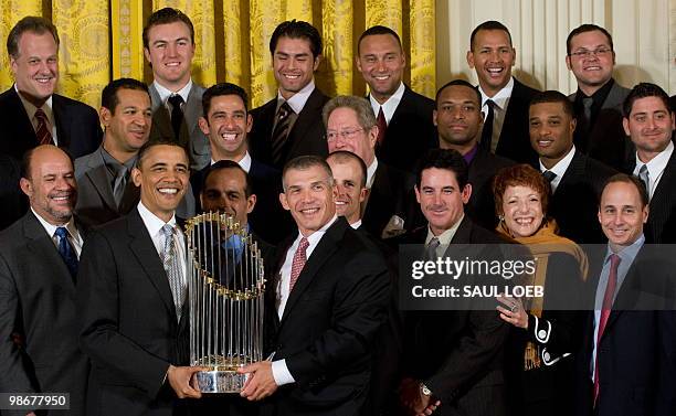 President Barack Obama holds the World Series Championship trophy with New York Yankees manager Joe Girardi, during an event with the 2009 World...