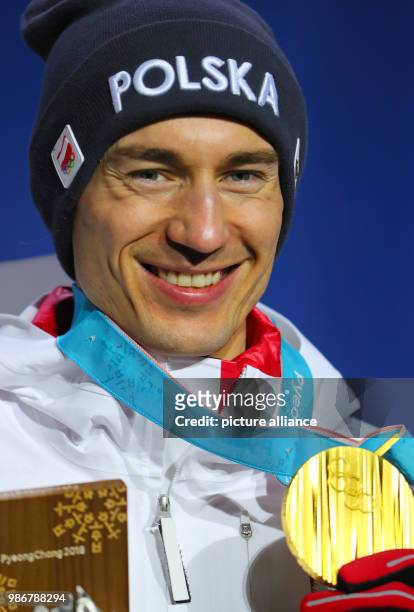 February 2018, South Korea, Pyeongchang, Olympics, Nordic Skiing, Ski Jumping, big hill, award ceremony, medal plaza: Kamil Stoch from Poland cheers...