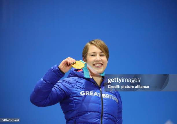 February 2018, Pyeongchang, South Korea, Olympics, womens, Skeleton, award ceremony Medal Plaza: Lizzy Yarnold of Great Britain holds up her gold...