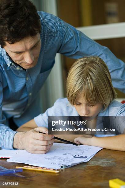 male junior high student looks as teacher checks assignment, close-up - junior high foto e immagini stock