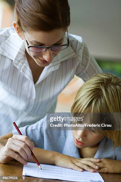 junior high student watching at teacher corrects classwork - junior high foto e immagini stock