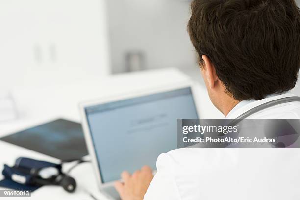 using laptop computer - over shoulder stock pictures, royalty-free photos & images