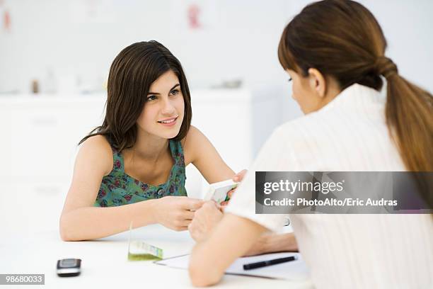 teenage girl discussing birth control pills with gynecologist - ginecologo foto e immagini stock