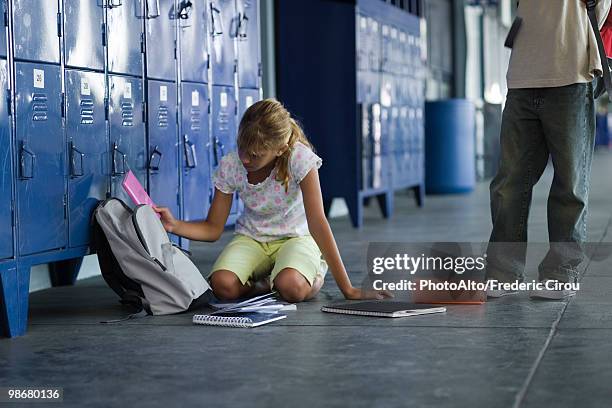 junior high student picking up dropped school supplies, boy standing by watching - low section stock pictures, royalty-free photos & images