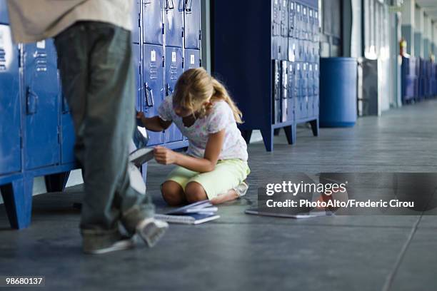 junior high student picking up dropped school supplies, boy standing by watching - aggression school stock pictures, royalty-free photos & images