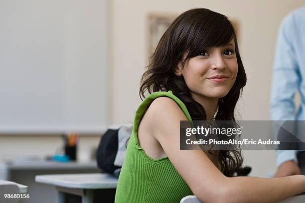 teenage girl in high school classroom - three quarter front view ストックフォトと画像