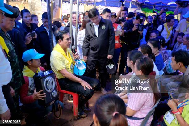 Thai Prime Minister Prayut Chan-O-Cha speaks to the family members of the missing children and their coach at Khun Nam Nang Non Forest Park after...