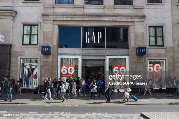 People walking in front of a GAP clothing shop in London. London is the Capital city of England and the United Kingdom, it is located in the south...