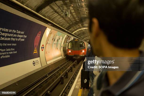 Passenger watches an incoming subway in London. London is the Capital city of England and the United Kingdom, it is located in the south east of the...