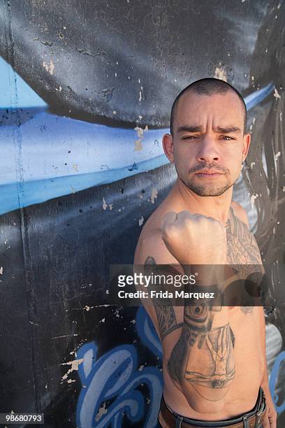 bare chested hispanic man with tattoos - mary madden stock pictures, royalty-free photos & images