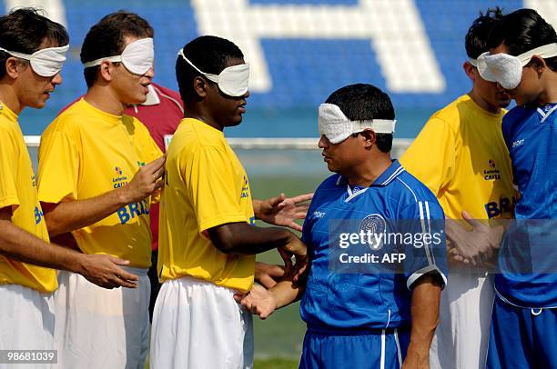 Brazilian and Salvadorean blind footballers shake hands before a match at Jorge El Magico Gonzalez stadium in San Salvador April 26, 2010. Blind...