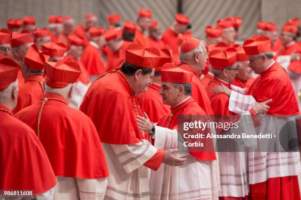 Newly appointed Cardinal Giovanni Angelo Becciu is greeted by cardinals during a consistory ceremony lead by Pope Francis to create 14 new cardinals...