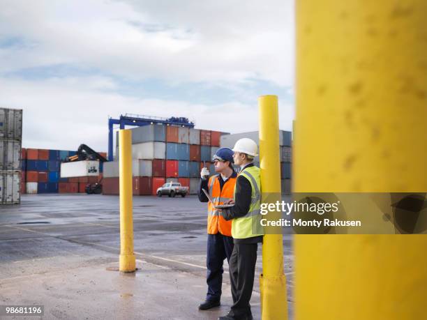 port workers with laptop and containers - luggage hold stock pictures, royalty-free photos & images