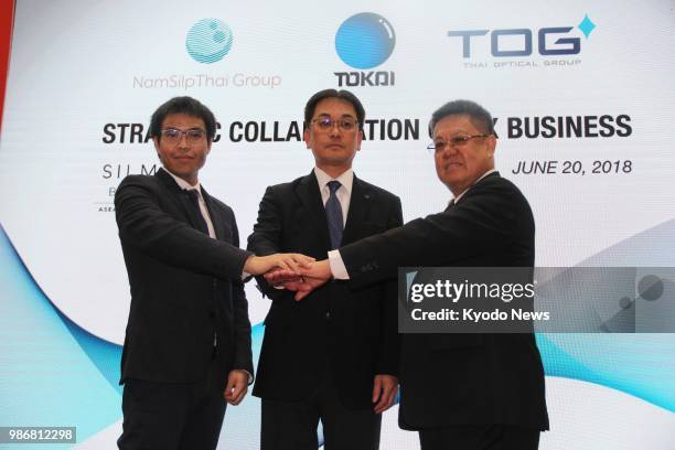 Hirokazu Furuzawa , president of Japanese lens manufacturer Tokai Optical Co., poses with Torn Pracharktam , managing director of Thailand's largest...