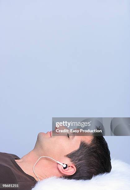 man listening to music, profile shot - easy listening music stock pictures, royalty-free photos & images