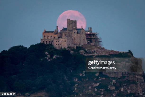 Full moon rises behind St Michael's Mount in Marazion near Penzance on June 28, 2018 in Cornwall, England. Tonight's strawberry moon, a name given to...