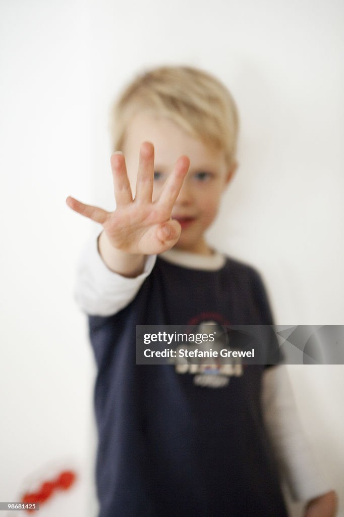 Boy pointing four fingers