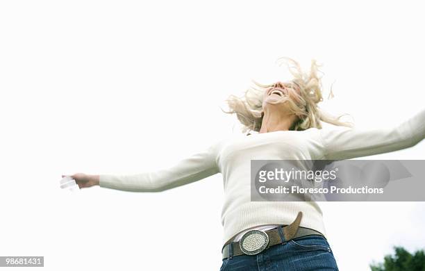 woman jumping with joy - hochgefühl stock-fotos und bilder