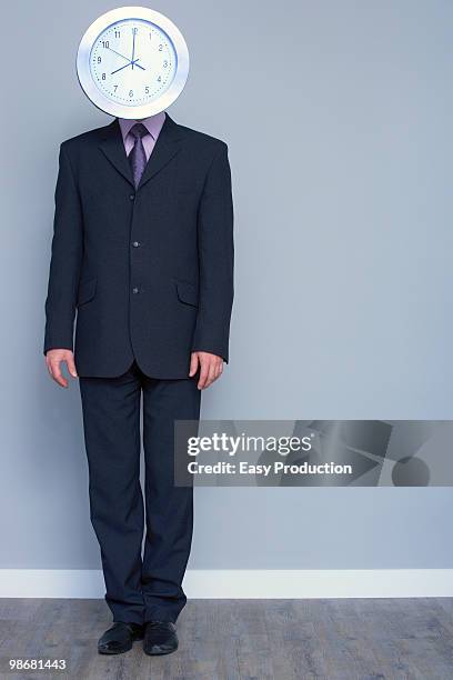 man in a suit with a clock head - overdoing stock pictures, royalty-free photos & images