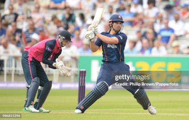 Essex batsman Alastair Cook hits out but is caught for 22 runs by Eoin Morgan of Middlesex during the NatWest T20 Blast match between Middlesex and...