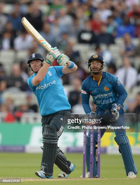 England batsman Ian Bell hits out watched by Sri Lanka's wicketkeeper Kumar Sangakkara during the 5th Royal London One Day International between...
