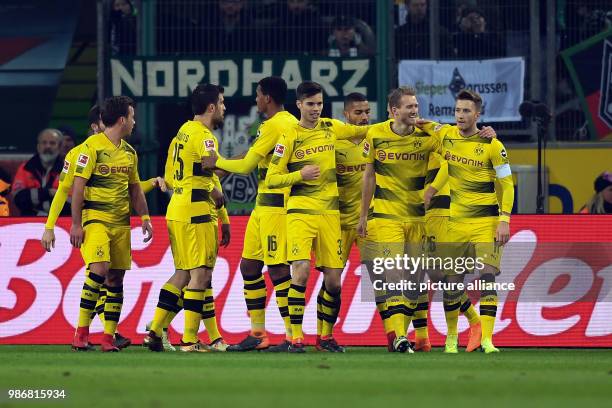 Dpatop - Dortmund's Marco Reus celebrates, with teammates, scoring his side's 1st goal, during the German Bundesliga soccer match between Borussia...