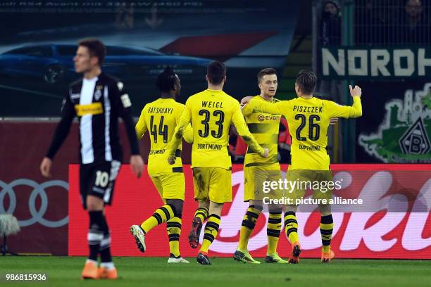 Dpatop - Dortmund's Marco Reus celebrates, with teammates, scoring his side's 1st goal, during the German Bundesliga soccer match between Borussia...